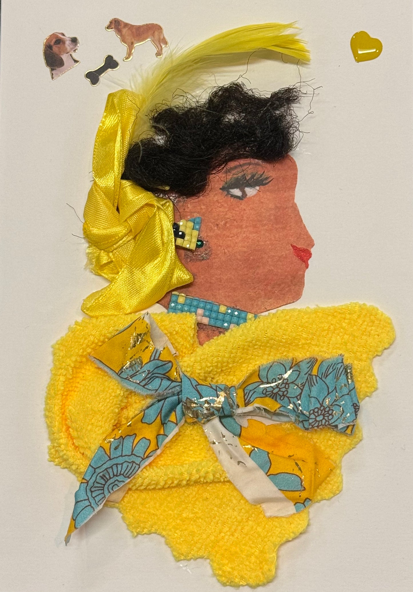 Handmade greeting card that doubles as a piece of art featuring a side-profile collage of a woman wearing a large yellow ribbon tied into her hair. She is dressed in textured yellow clothing, with layered materials and a patterned bow detail that adds dimension to the outfit. The bright yellow tones dominate the composition, creating a cheerful and cohesive look. Above her head to the left, small dog stickers are placed alongside a tiny yellow heart, introducing a playful and whimsical element.