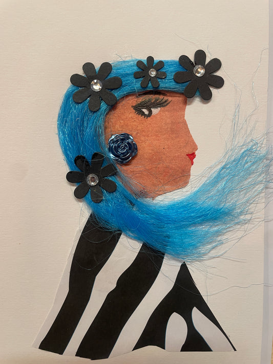 Handmade card of a woman in profile with vivid blue flowing hair decorated with black flower shapes and shiny gems. She wears a navy blue rose earring and a black-and-white striped outfit.