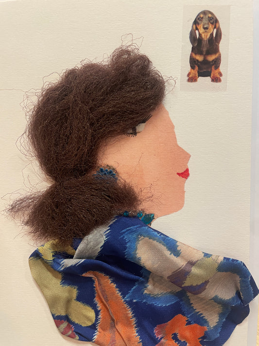 This is a handmade card of a woman named Astonishing Aishwarya, wearing textured brown hair, blue-and-orange floral fabric around her shoulders, and teal beads around her neck. A lovely dog is found in the top right corner.