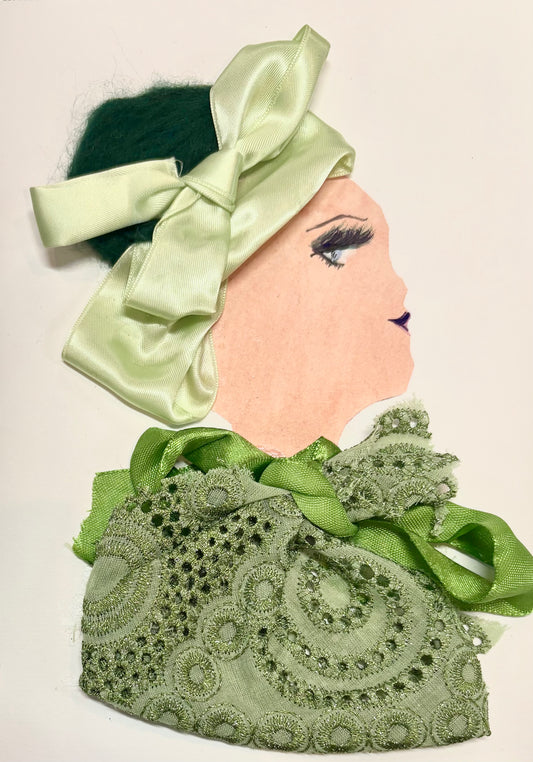 A woman wears a pale green headband and a green lace blouse. There is a grass green bow at the neckline of her blouse.