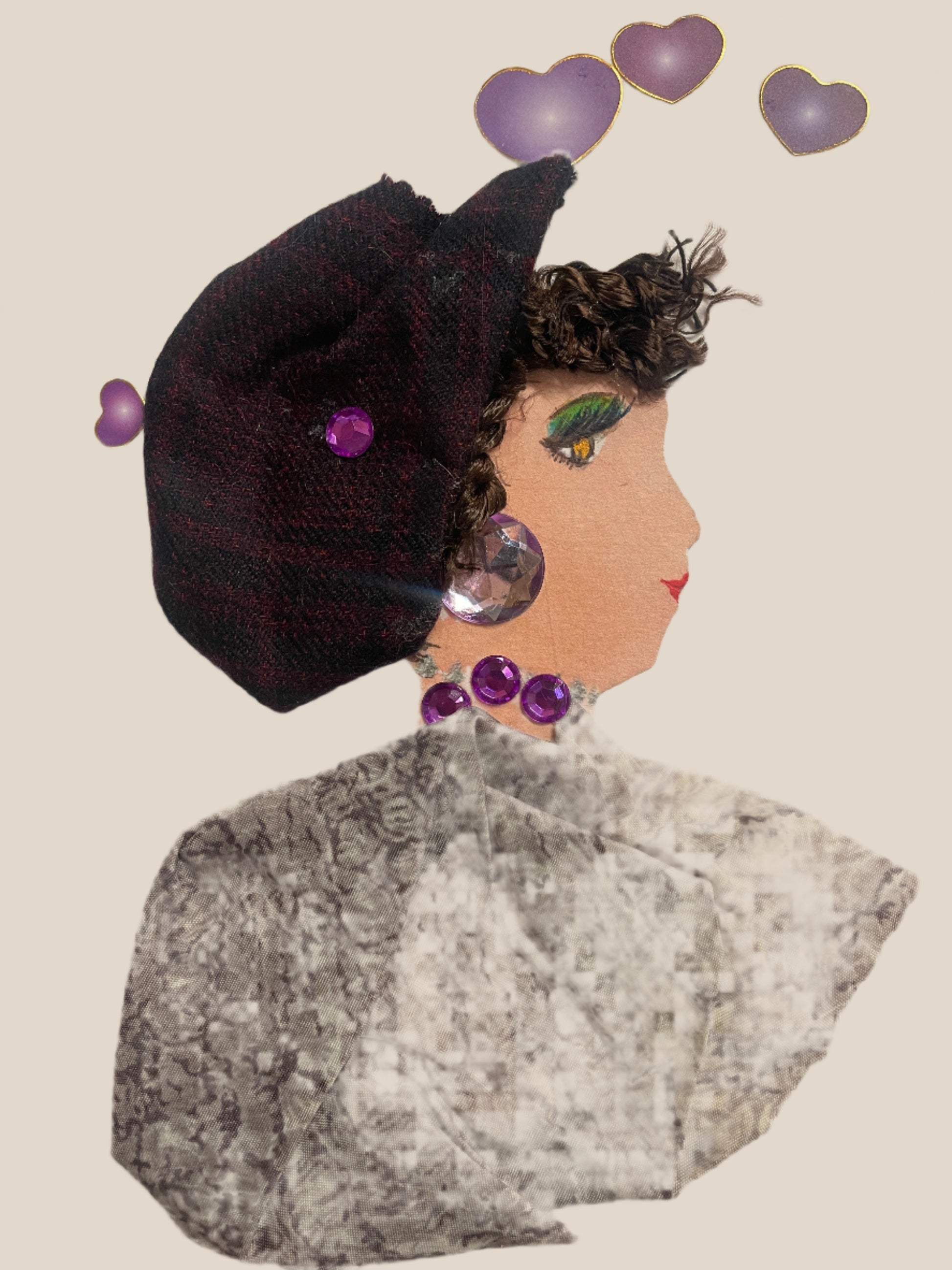 This is a handmade card of a woman named Baker Brixton. She has curly hair, a burgundy checked cap with a gem, and a textured grey blouse. Purple heart stickers decorate the background.