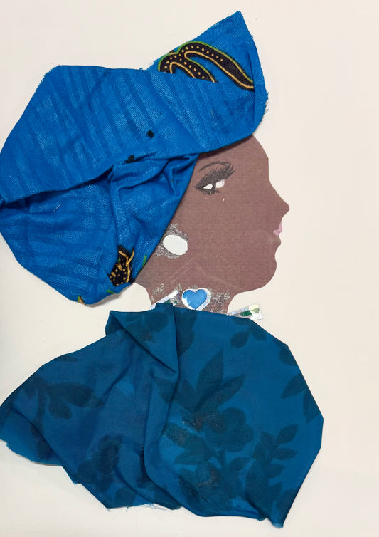 A woman wears a royal blue headwrap featuring a subtle stripe pattern. Her blouse is blue and features a monochromatic dark blue floral design. Her necklace has a blue heart and she wears a white earring.