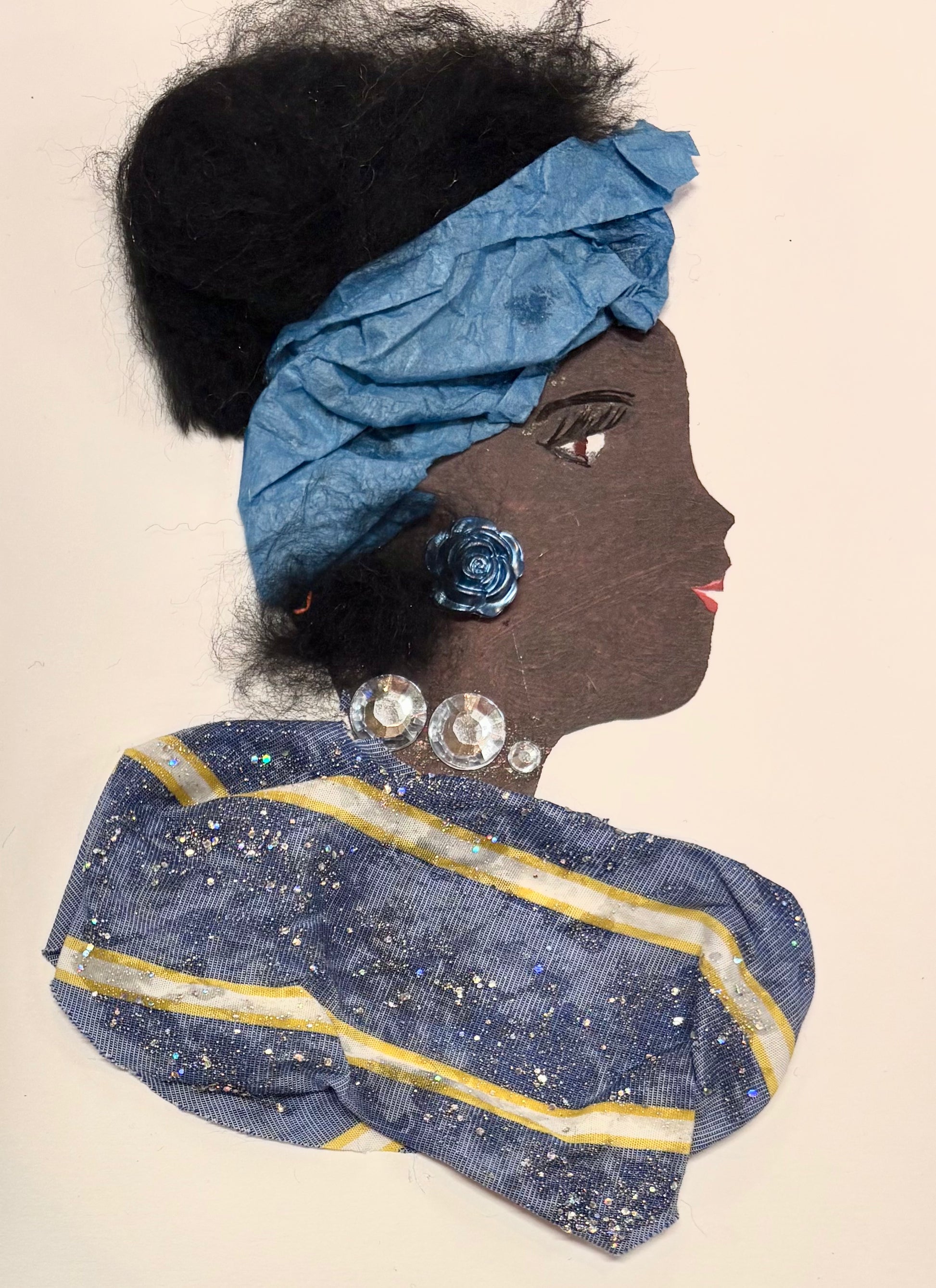 A woman wears a blue headband, with her dark hair in an updo. Her blouse is blue with two horizontal yellow stripes. She wears a blue rose earring and silver gems as a necklace.