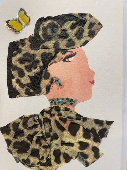 A handmade card of a woman named Butterfly Brixton in profile dressed in greenish leopard fabric with a matching headwrap. She wears green and silver jewellery, with a yellow butterfly sticker in the corner.