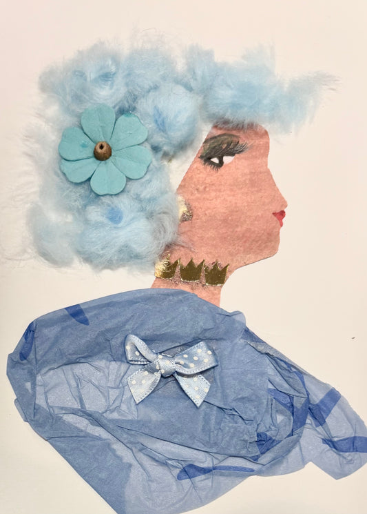 A woman has baby blue hair made of cotton balls and a blue flower in her hair. She wears a blue blouse with a little baby blue bow with white polka dots. Her necklace is gold.
