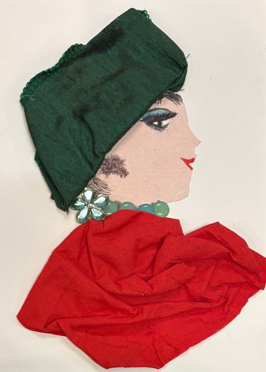 Handmade portrait of a woman in profile. She wears a dark green headwrap and a red fabric dress. Her jewellery includes a large light blue flower earring and round green beads around her neck. She has bold eye makeup and red lipstick.