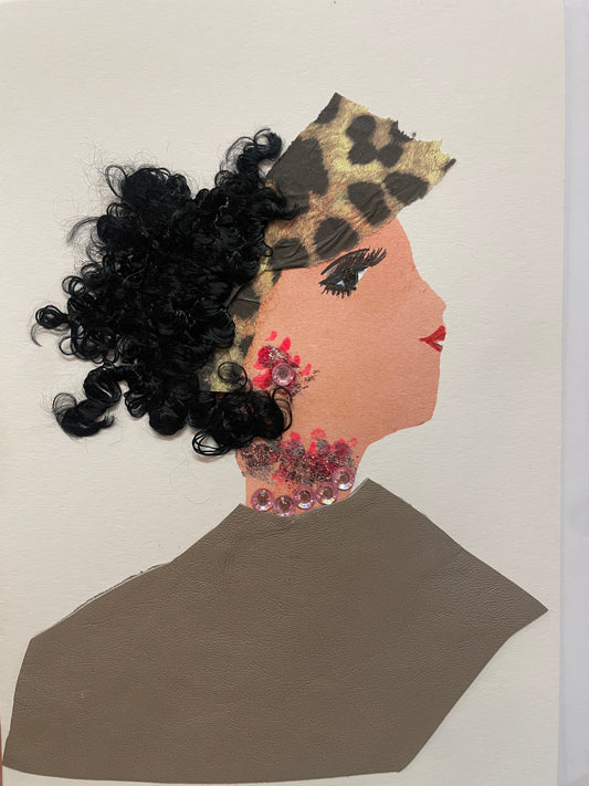 This is a handmade card of a woman named Creative Caitlin, wearing a taupe top, leopard-print head wrap, curly black hair, and pink gem jewellery around her neck and ear.