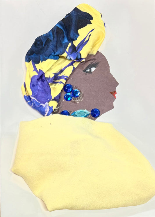 A handmade greeting card featuring a woman in profile, wearing a yellow and blue floral headwrap and a soft yellow outfit. She is adorned with shiny blue and turquoise gem decorations.
