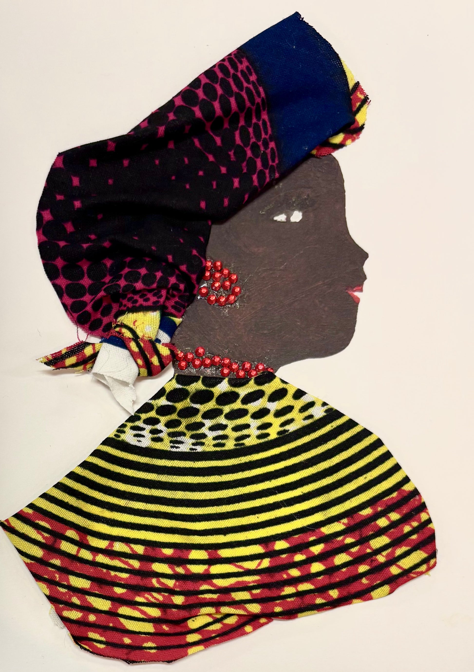 Elegant Elsie exudes vibrant sophistication, adorned in a bold, patterned ensemble of magenta, navy, yellow, and black. Her beaded red jewelry adds a regal touch, while her composed profile and gracefully wrapped headscarf evoke a timeless strength rooted in cultural pride.