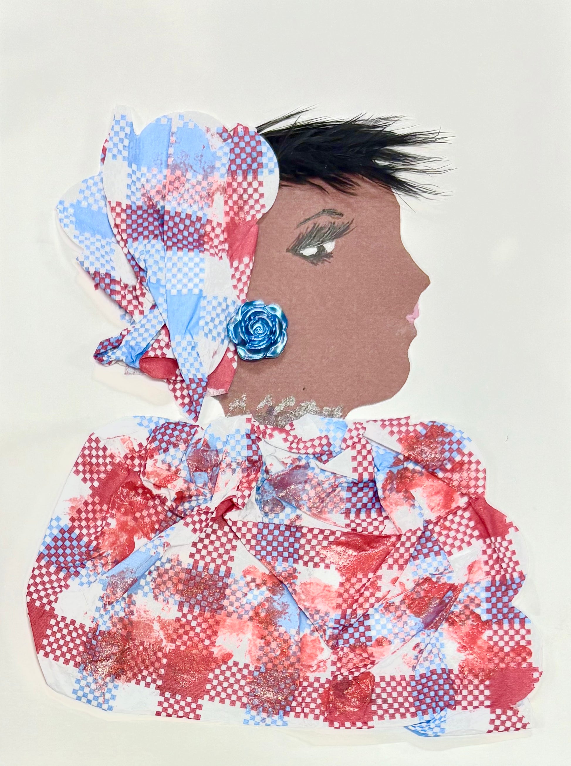 A handmade greeting card featuring a woman in profile, wearing a red, white and blue checkered headwrap and matching outfit with painted red details. She has short black hair and a blue rose-shaped earring.
