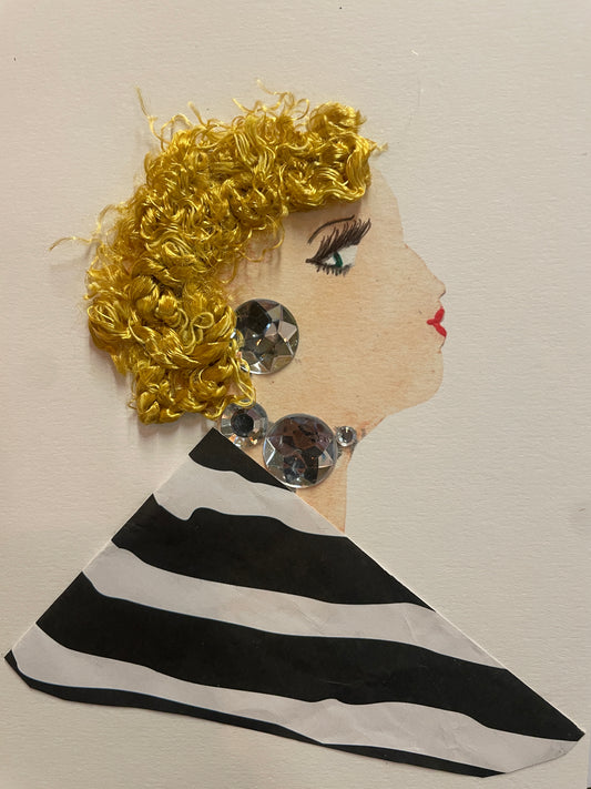 A handmade card of a woman in profile with curly golden hair and large silver gem earrings. She wears a bold black-and-white striped blouse.