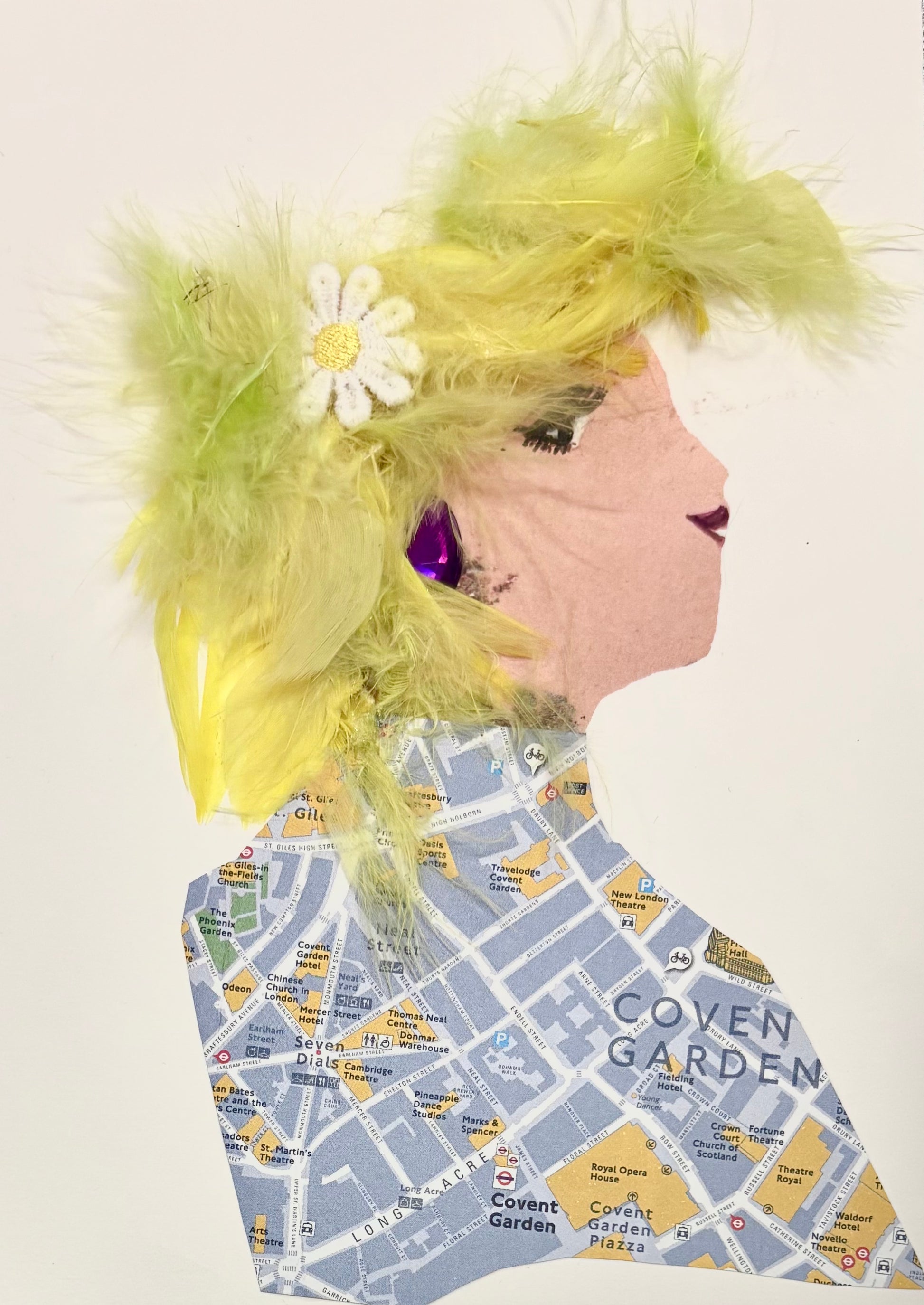 This one of a kind card was delightfully handmade. The woman featured has yellow feathered hair and a daisy as an accessory. She wears a map inspired blouse and a purple earring