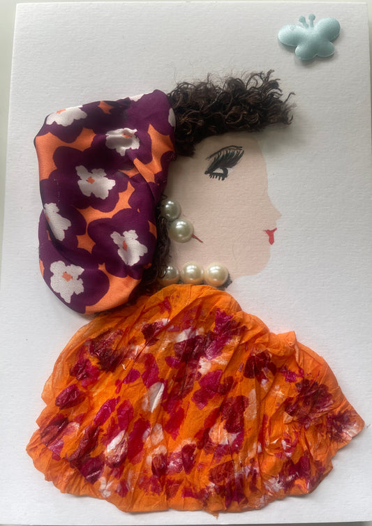 This is a handmade card of a woman named Paree Peckham. She wears a purple and orange floral headwrap, an orange blouse with red prints, pearl jewellery, and a blue butterfly sticker in the corner.