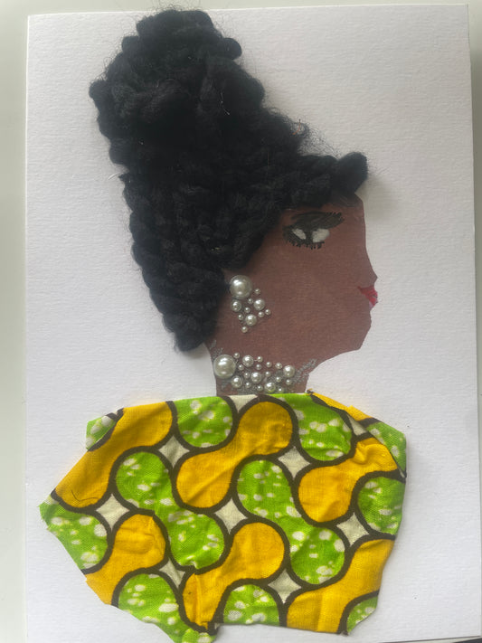This is a handmade card of a woman named Happy Happy. She has a large braided bun, pearl jewellery, and a green and yellow patterned blouse. The background is plain.