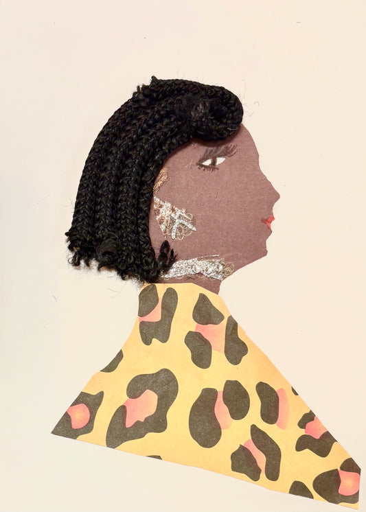 I handmade this card of a woman named Aldgate Allie. She’s shown in profile with red lips, and long lashes. Her hair is made of braided black yarn, styled in a short bob. She wears sparkling silver accents on her ear and neck, and a bold leopard-print outfit in yellow, brown, and soft pink.