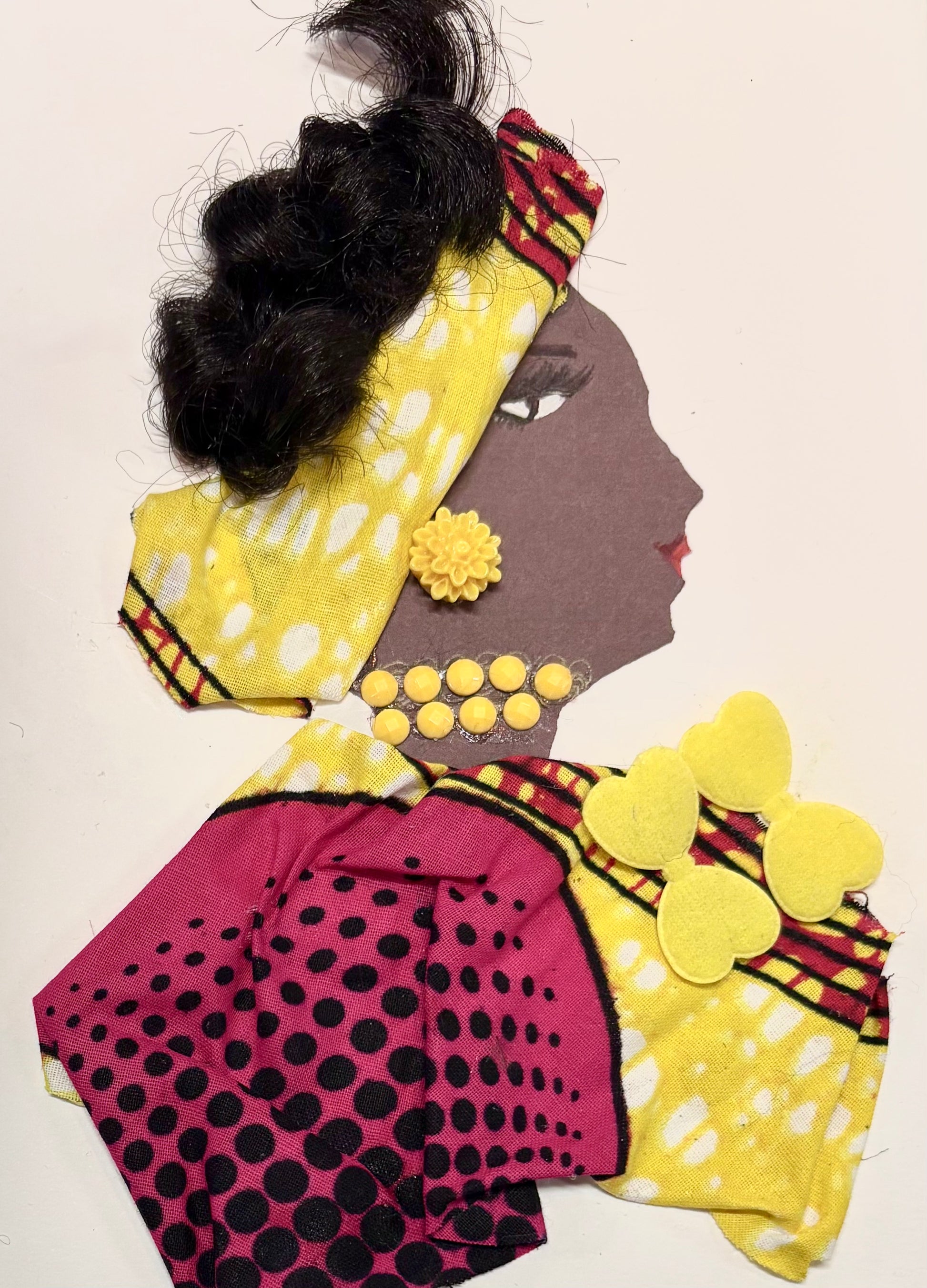 I handmade this card of a woman named Lady Delaney. She wears her hair in elegant waves, wrapped with yellow and red patterned fabric. Her outfit is a mix of bright yellow and deep pink with black dots, and she’s adorned with yellow hearts, a daisy earring, and a necklace made of yellow gems.