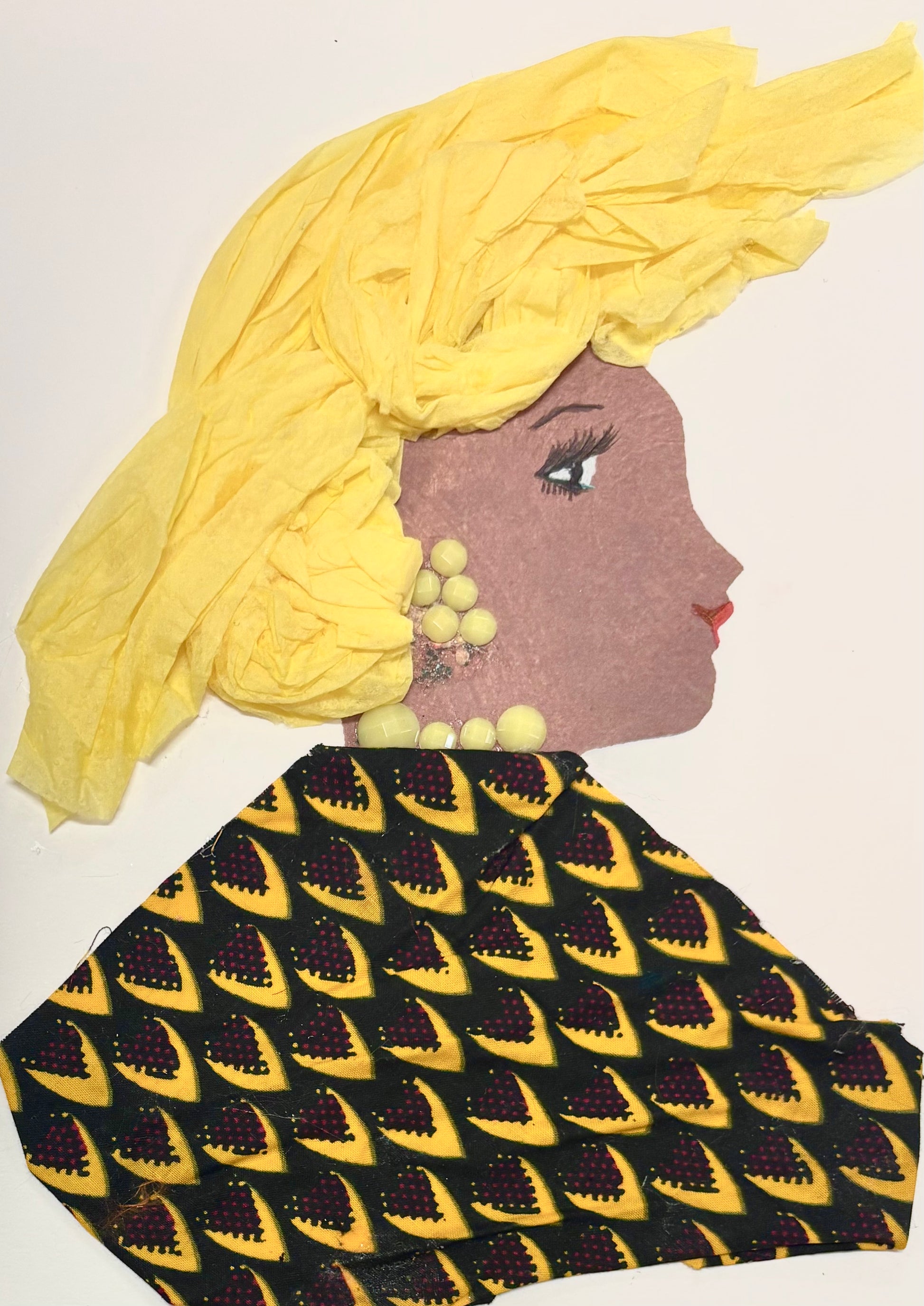 A woman wears a bright yellow headwrap and a ankara patterned blouse featuring yellow, red, and black. Her jewellery is made up of circular yellow gems.