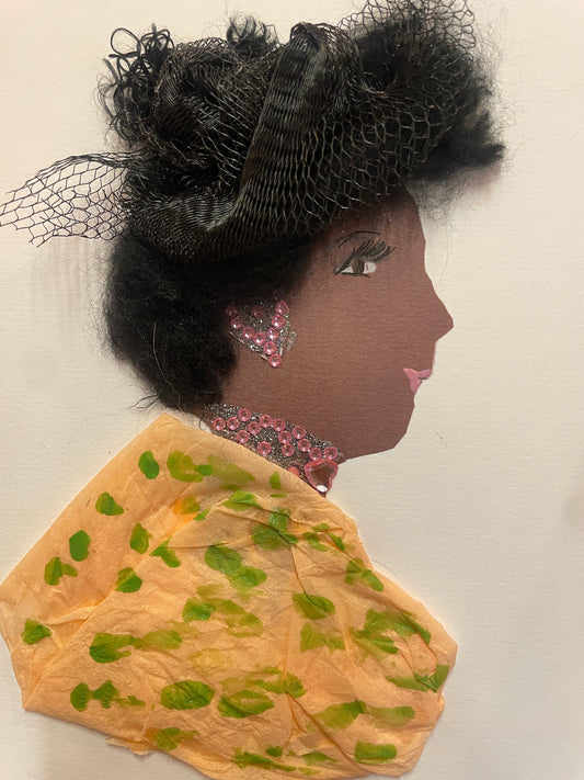 A handmade card of a woman wearing a textured black netted headpiece and a soft orange outfit with green blotches. She has a pink beaded necklace and matching triangle earring.