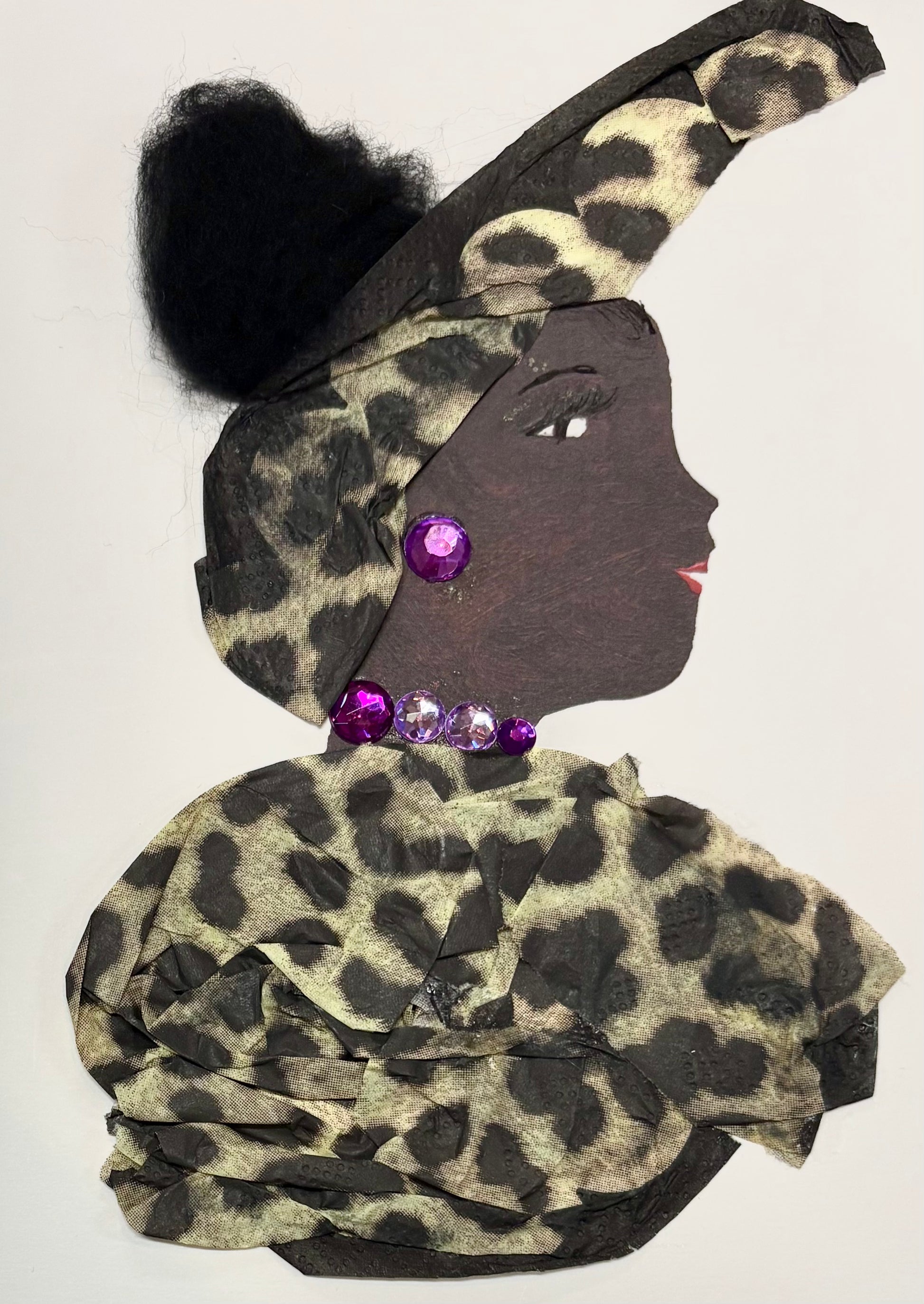 I handmade this card of a woman named Lady Moorgate. She’s shown in profile with defined lashes, red lips, and voluminous black textured hair. Her outfit and high-wrapped headscarf are made from leopard-print fabric, and she’s adorned with bold purple and pink gemstones on her ear and neckline.