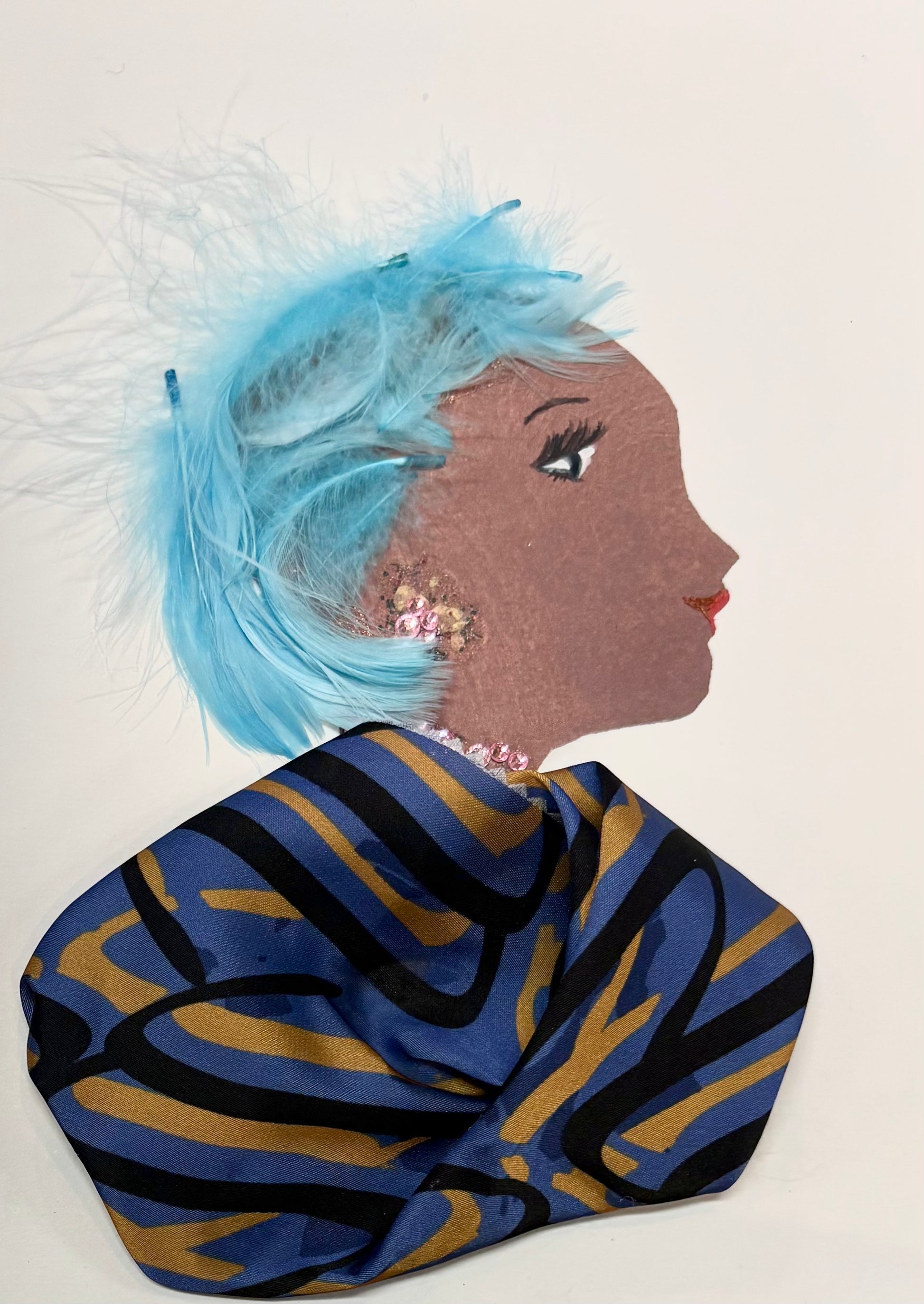 A woman has bright blue hair made of feathers. Her blouse has a swirling stripe pattern consisting of blues, blacks, and yellow. She has subtle light pink jewellery.