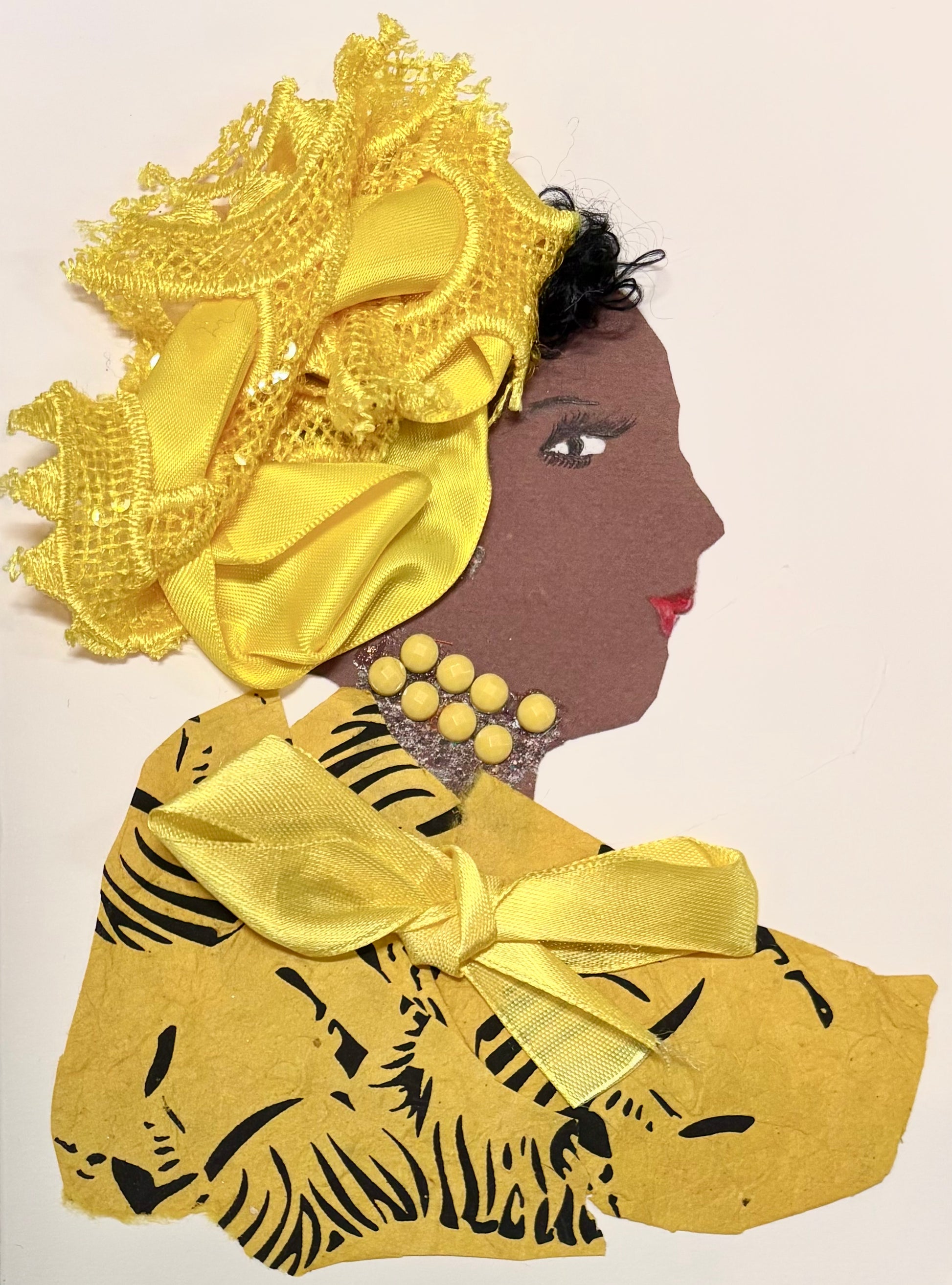 I handmade this card of a woman named Lemon Zest. She wears a large, bright yellow headpiece made of satin and lace, decorated with sequins. Her outfit is yellow with bold black tiger-stripe patterns and is tied with a yellow satin bow. She wears a necklace of round yellow beads and matching earrings.