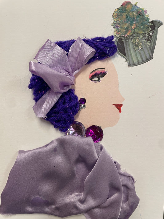 Handmade card featuring a side-profile of a woman with purple yarn hair tied in a lavender bow, sparkly gem earrings, and a draped lavender top. A small image of a watering can filled with colorful flowers appears in the right corner above her head.