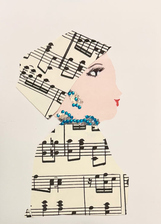 I handmade this card of a woman named Mornington Mia. She’s shown in profile with soft features, red lips, and graceful eye makeup. Her headwrap and outfit are made from printed sheet music, wrapping her in melody. She wears sparkling turquoise and silver embellishments along her ear and neckline, adding rhythm and shine to her elegant look.