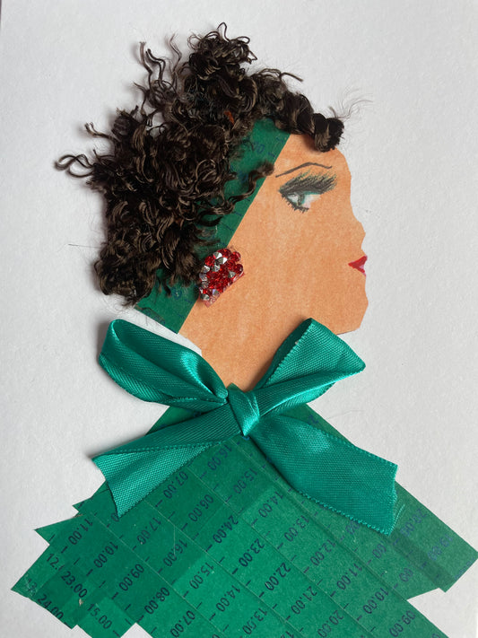 This is handmade card of a woman named Olympia Olivia. She’s dressed in deep green made from time-stamped strips, finished with a silky bow at her collar. Her curly hair is tucked beneath a matching headband, and a red jewel earring adds a quiet sparkle.