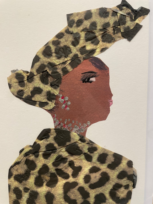 A handmade card of a woman named Peckham Pearl in profile wearing a muted brown and black leopard-patterned outfit and matching headwrap. Her jewellery is made of pink gems and silver accents.