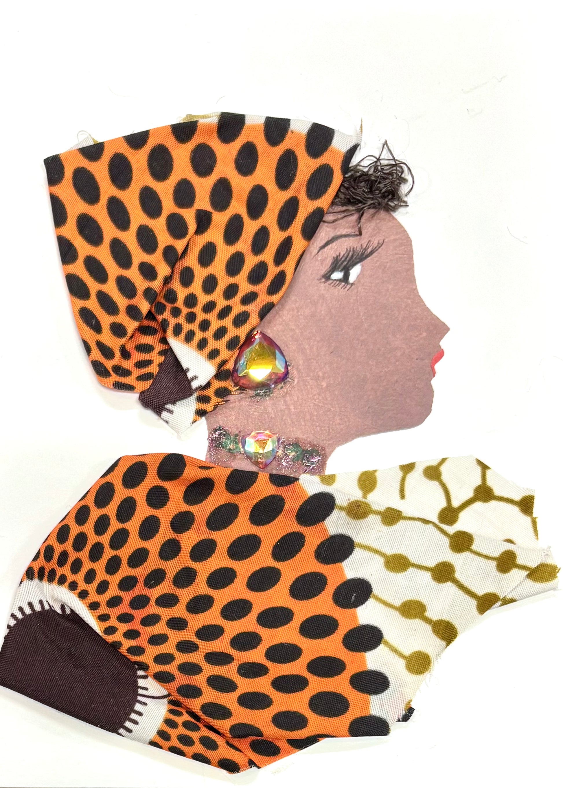 Handmade portrait of a woman in profile. She wears a bold orange and black polka-dot headwrap and a matching outfit with a mix of white and gold patterned fabric. Her jewellery includes large iridescent gems on her ear and neck.