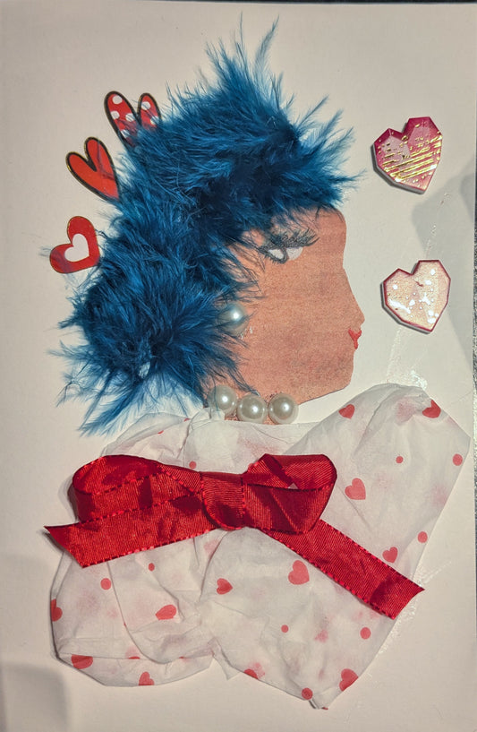 This is a handmade portrait of **Ruth Rosy**. She wears a soft white dress patterned with tiny red hearts, cinched at the waist with a vivid red ribbon bow. Her hair is styled with a dramatic flourish of bright blue feathers, adding flair and elegance. She’s adorned with a classic strand of pearl-like beads at her neck, and surrounded by hearts in varying shades of red and pink, perfectly matching her affectionate name.