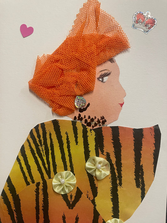 This is a handmade card of a woman named Serena Soho. She wears a vibrant orange net hat, tiger-striped clothing with yellow rosettes, and glittery earrings. A pink heart and crown sticker float in the background.