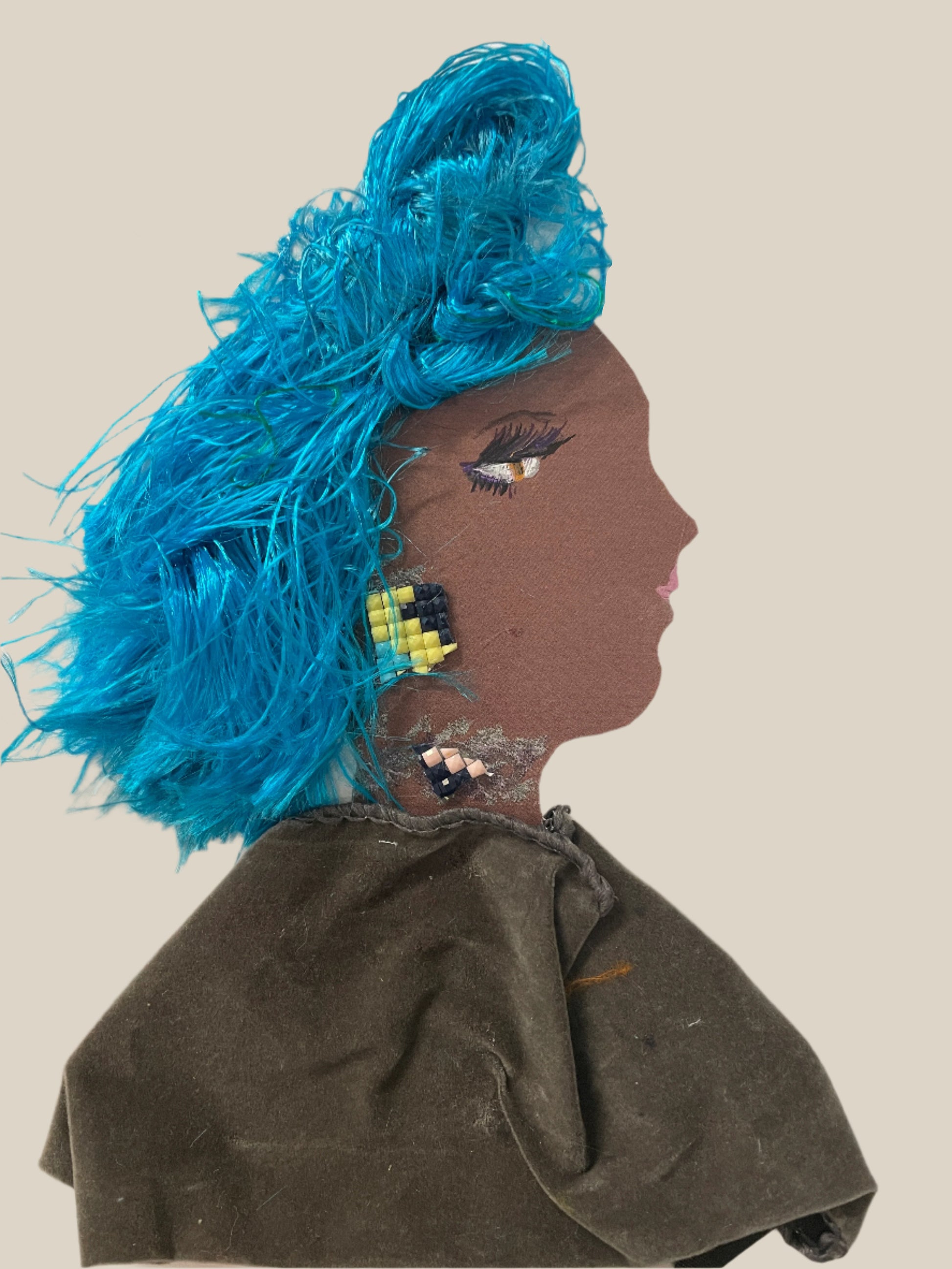 This is a handmade card of a woman named Skyla Brixton. She has bright blue textured hair, beaded earrings and necklace, and wears a soft brown velvet top.