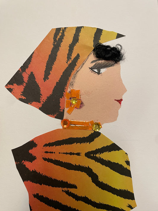Handmade card of a woman in profile wearing a matching orange-yellow tiger-print headwrap and dress. She has curly black bangs, sparkly gold earrings, and a gem neckpiece.