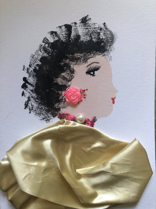 This is a handmade card of a woman named Sweet Potato Chief. Her hair is painted in bold black brushstrokes, giving a soft, natural texture. She wears a shiny gold fabric outfit. A small pink rose sits on her ear like an earring, and a pearl rests at her neck above a pink and black necklace.