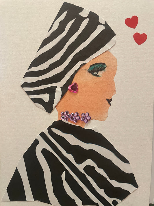 This is a handmade card of a woman named Taylor wearing zebra-striped attire and a matching head wrap. She has green eyeshadow, a pink heart earring, and a floral purple necklace. Red hearts can be found in the top right corner