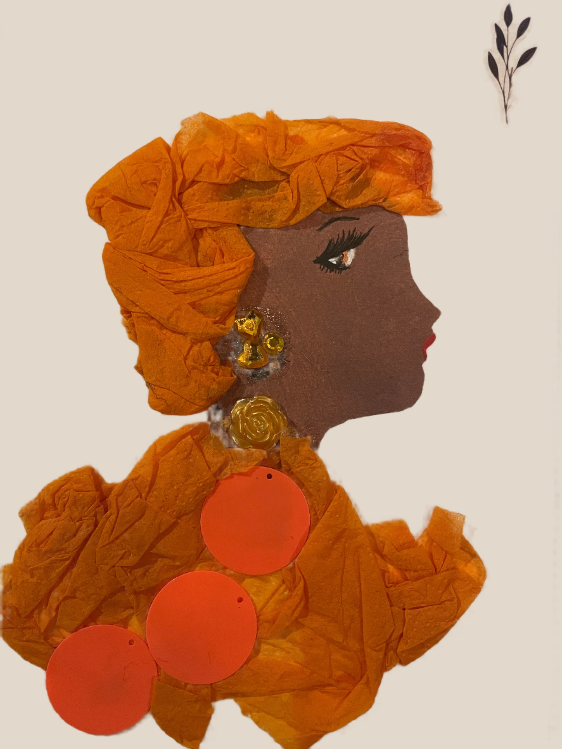 This is a handmade card of a woman named Zahara Ember. She wears an orange wrap and dress with large circular decorations, a gold rose accessory at her neck, and yellow earrings.