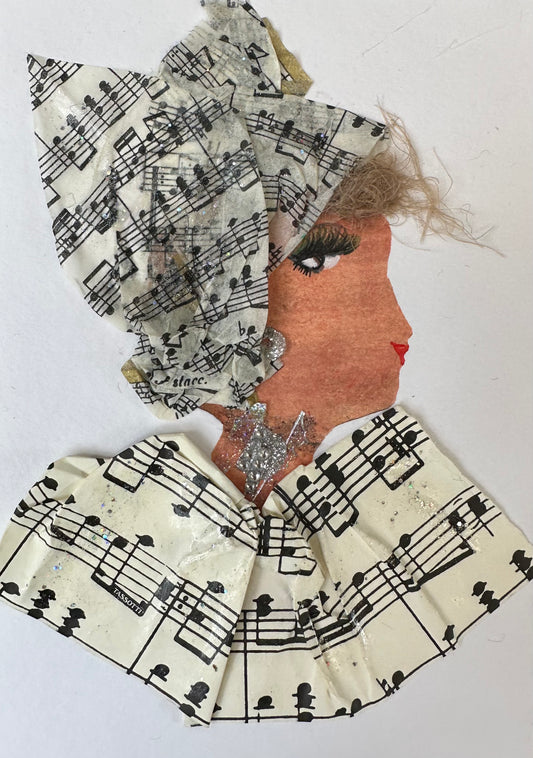 I designed this handmade card of a woman dressed in a blouse and hatinator that are patterned with sheet music. The music notes on the hatinator are smaller than those of the blouse. Her outfit is completed with silver gemstone earrings.