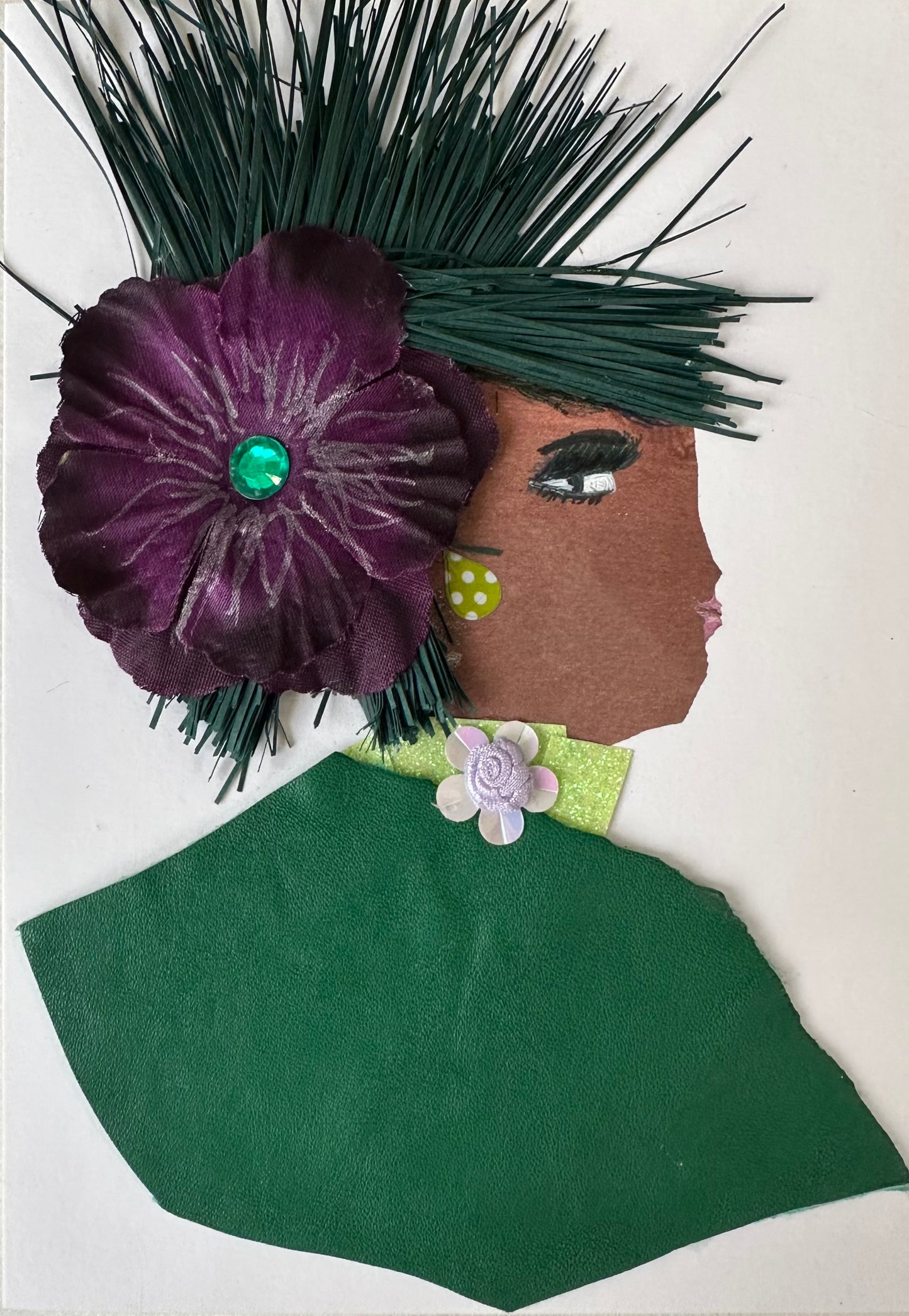 I made this handmade card of a woman with an emerald green blouse. In her hair is a tropical-like purple flower with palms.