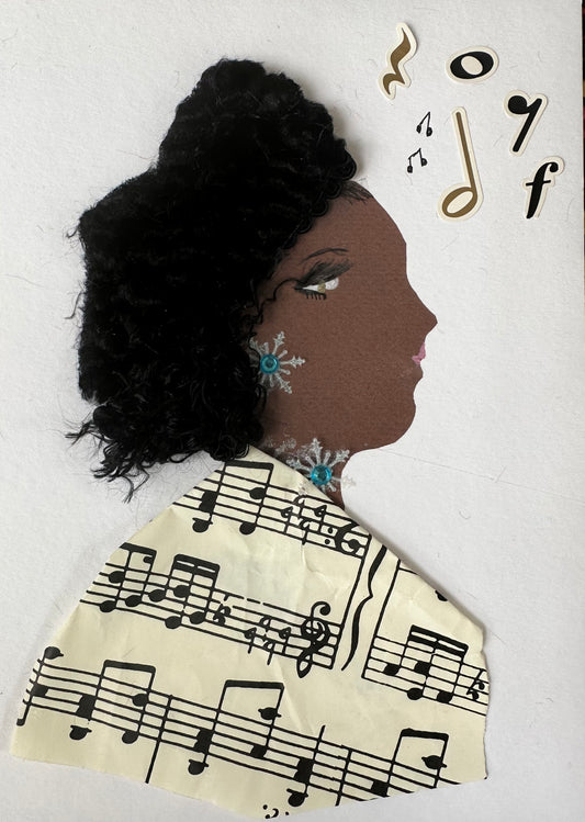 I designed this handmade card of a woman dressed in a blouse that is made of a sheet of music. She has snowflakes shaped jewellery, as well as music notes floating along the page.