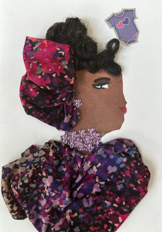 I designed this handmade card of Mayfair Mae who is dressed in a purple floral blouse with a matching hatinator. Her necklace and earrings are composed of light purple gemstones. Additionally, there is a light purple baby romper in the corner.
