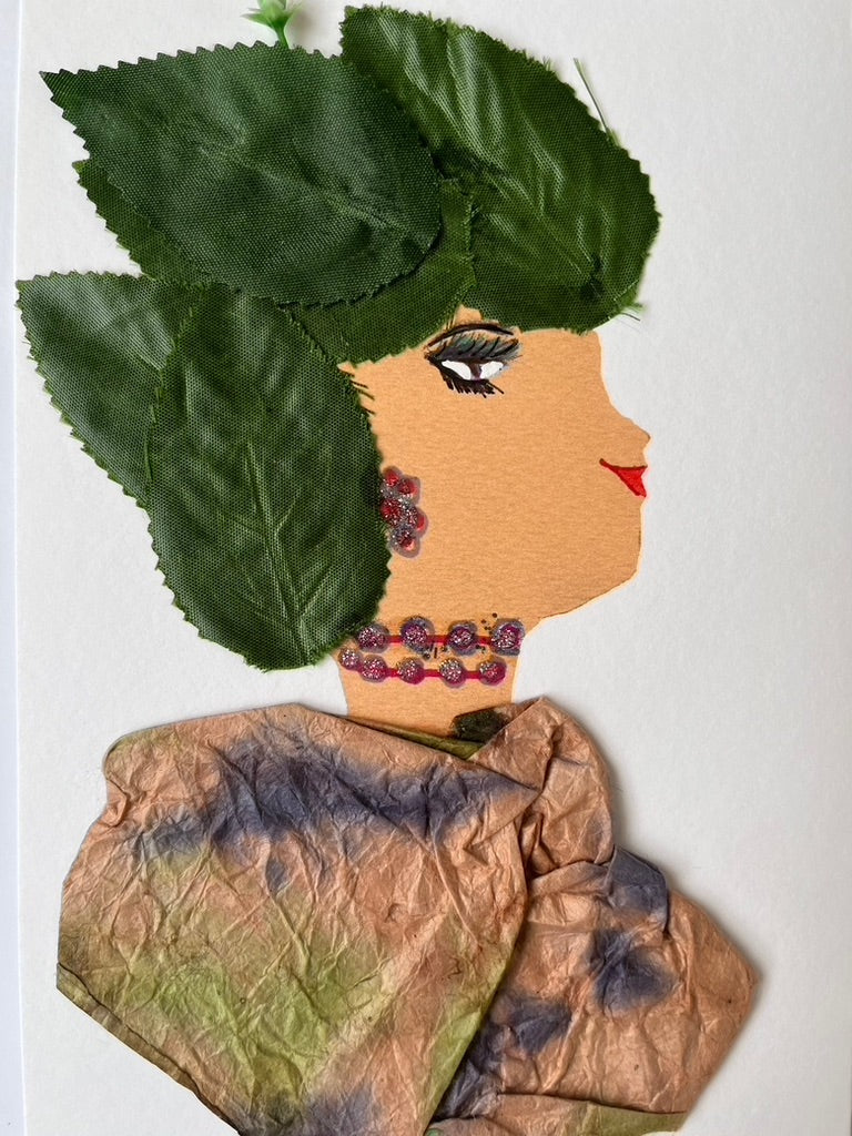 She wears a multicoloured paper blouse and leaves as her headdress.