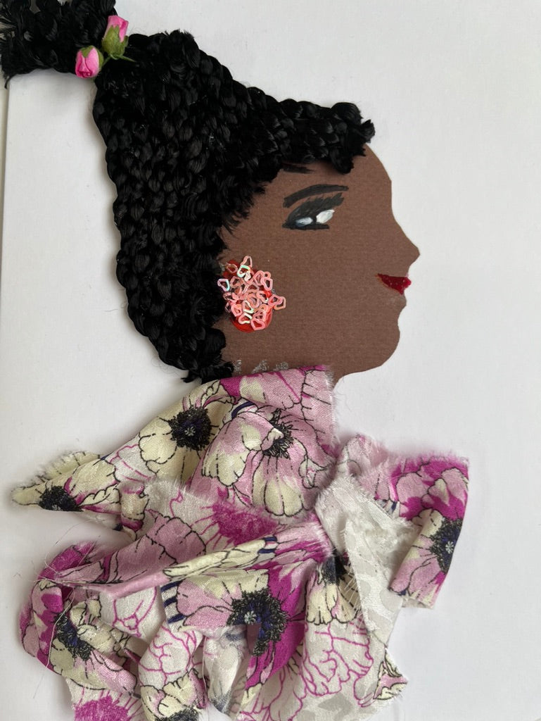 This card is called Paulina. She wears a purple floral print blouse, and her braided hair up in a ponytail with two small roses in it.