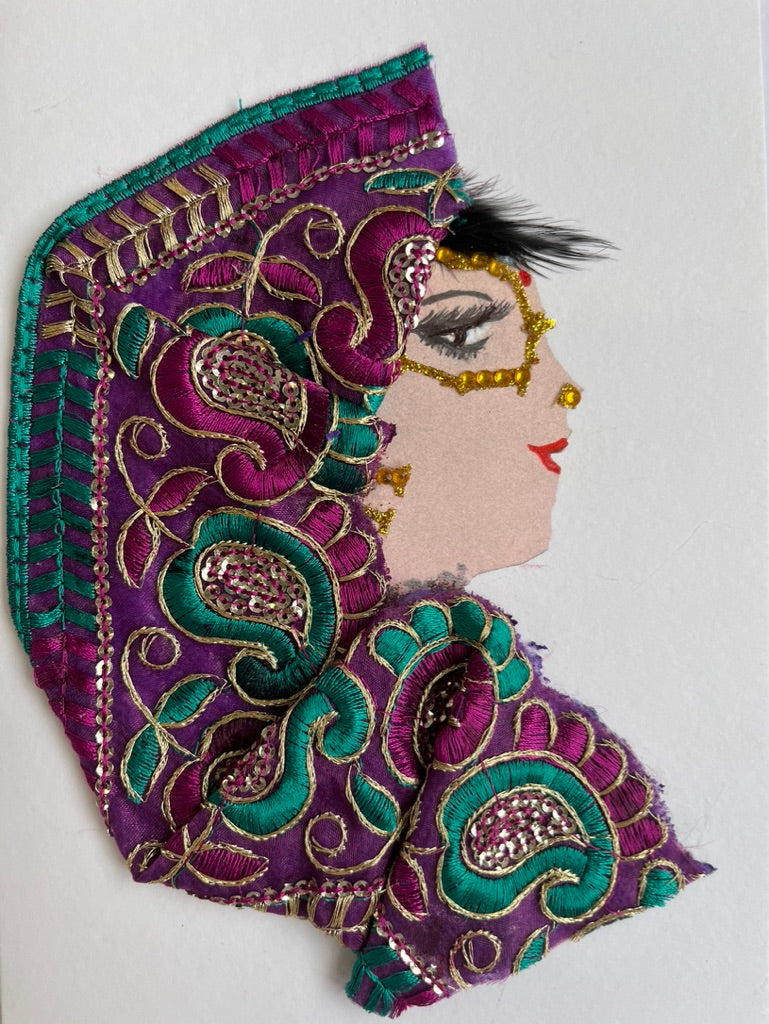 This card is named Renee. She wears a headdress that is purple and green paisley print, and traditional gold face jewellery.
