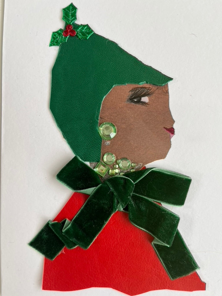 This card is called Milly Merry. Milly wears a red blouse with a green velvet bow and a green hat which has mistletoe on top.