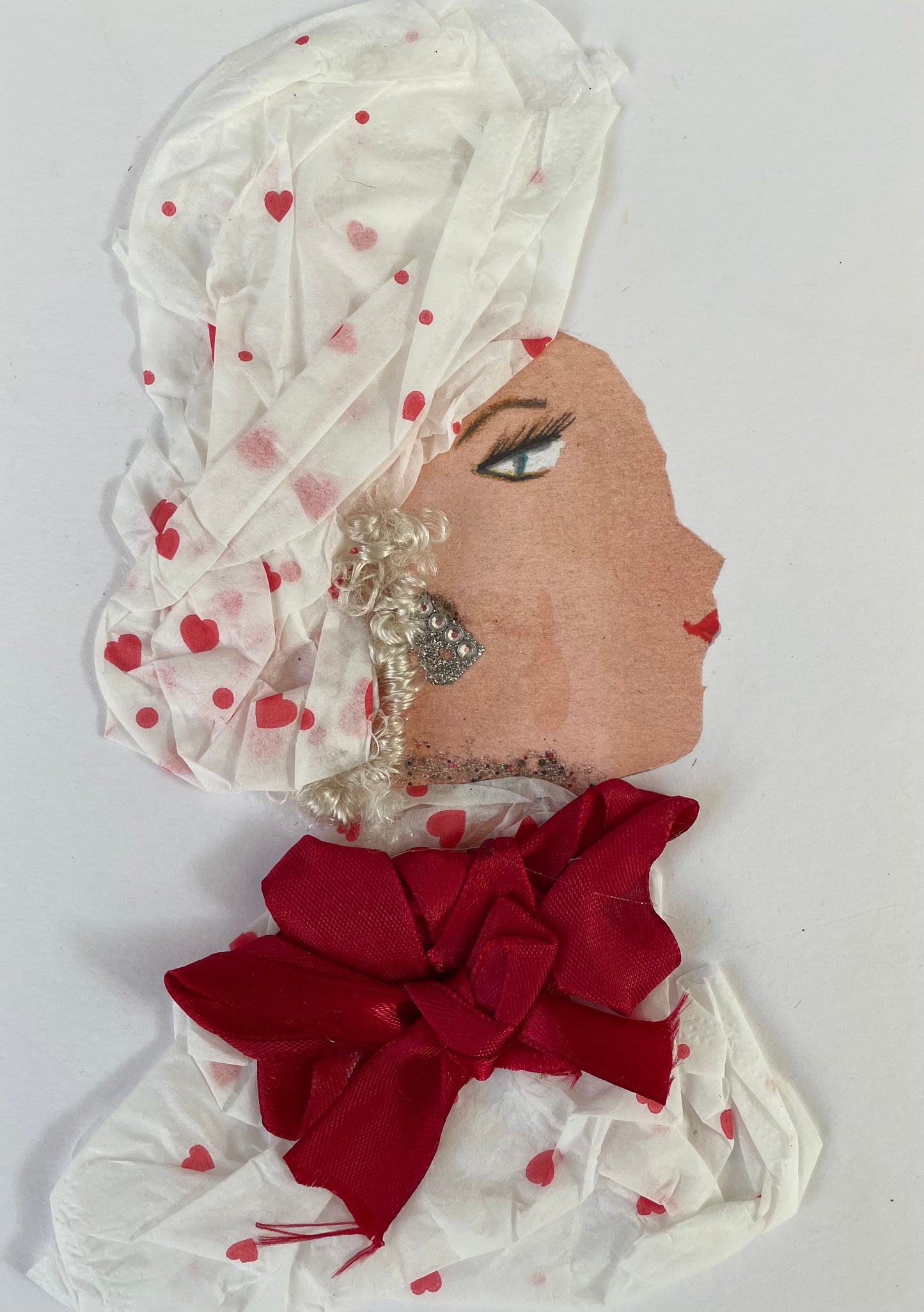 I designed this card of a woman named Doctor Alexandra Arnos. She has a white skin tone and is wearing a white blouse with small red hearts. She has a matching headpiece to compliment her blouse. She has blonde hair that is popping out. Upon her blouse is a dark red bow. Alexandra Arnos is wearing a silver necklace with diamanté silver earrings.