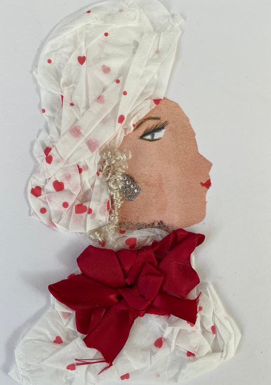 I designed this card of a woman named Doctor Alexandra Arnos. She has a white skin tone and is wearing a white blouse with small red hearts. She has a matching headpiece to compliment her blouse. She has blonde hair that is popping out. Upon her blouse is a dark red bow. Alexandra Arnos is wearing a silver necklace with diamanté silver earrings.