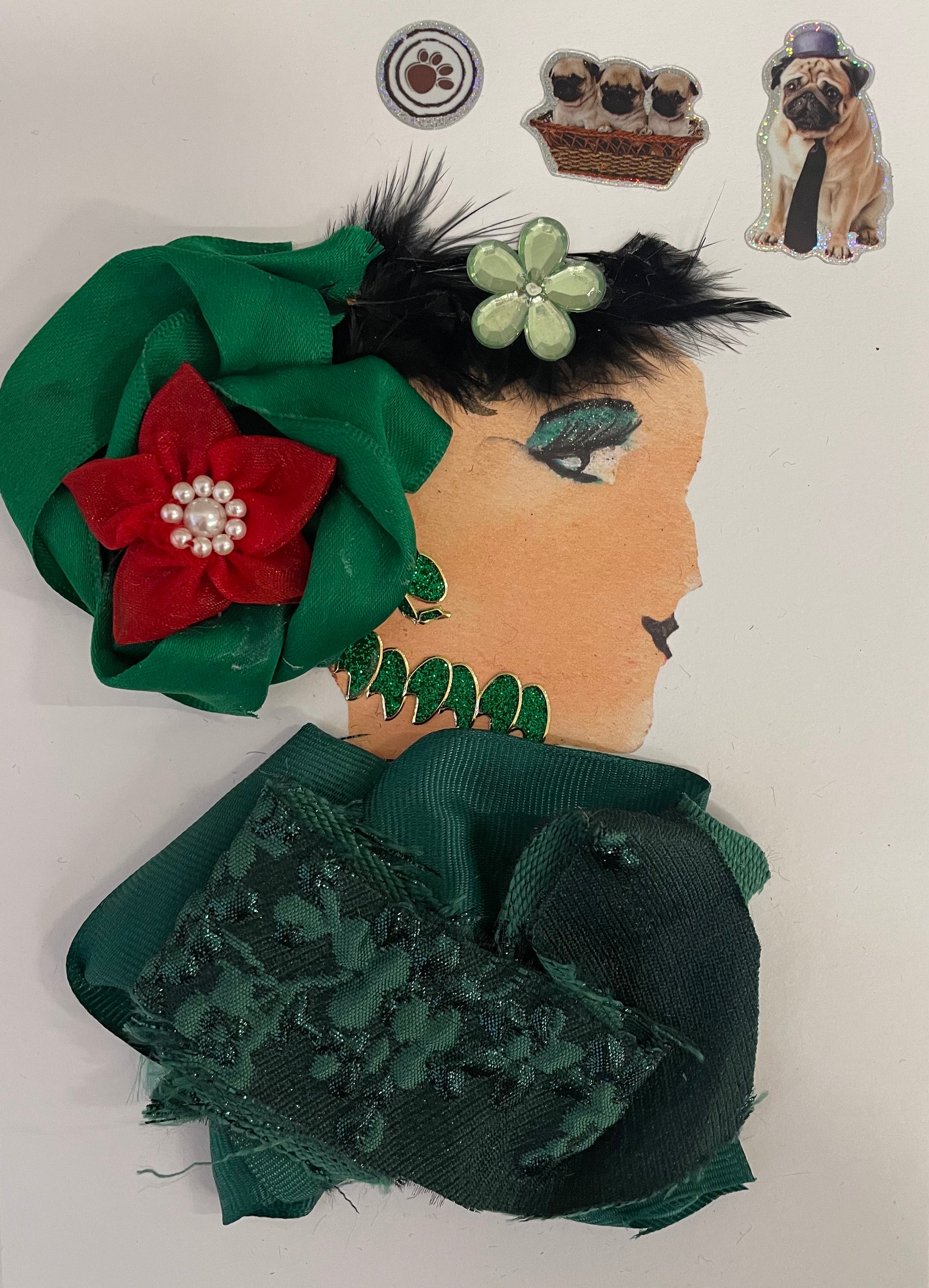 is wearing an emerald green blouse with a bright green hair accessory with a red flower on top. There is also a light green flower in her hair. She has a matching glittery green necklace and earrings. There is a paw sticker, 3 pugs together sticker and a dog with a tie and hat sticker!
