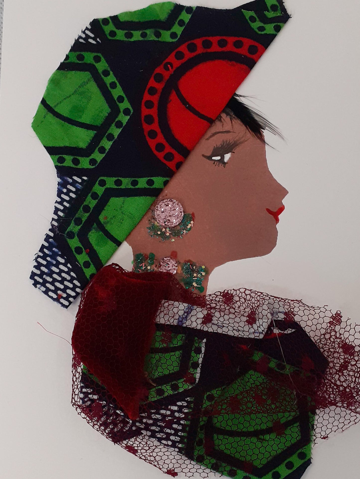 This card displays a woman given the name Doctor Temple Town. She wears a green patterned fabric with a red mesh overlay, and a headdress that matches the underneath fabric. Her earrings are a glittery pink gem as is her necklace.