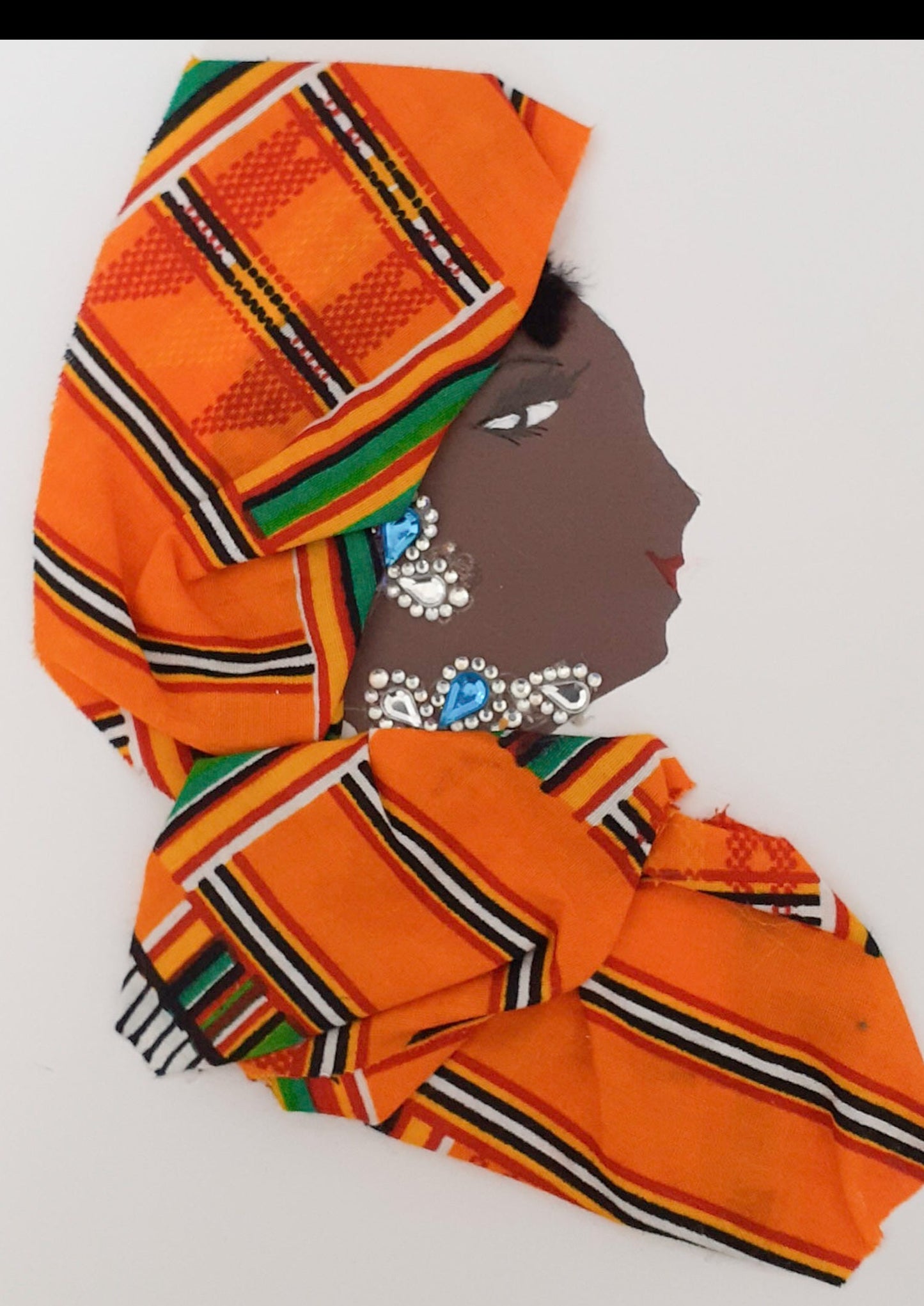 This card is called Naomi Netley. She wears a matching orange striped headdress and blouse, and blue crystal Jewellery.